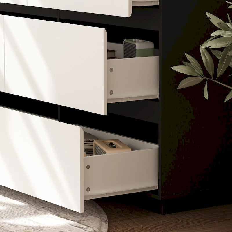 Commode de chambre à 4 tiroirs sans poignées, blanc et noir, avec rangement.